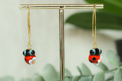 Pendientes largos dorados de mariquita